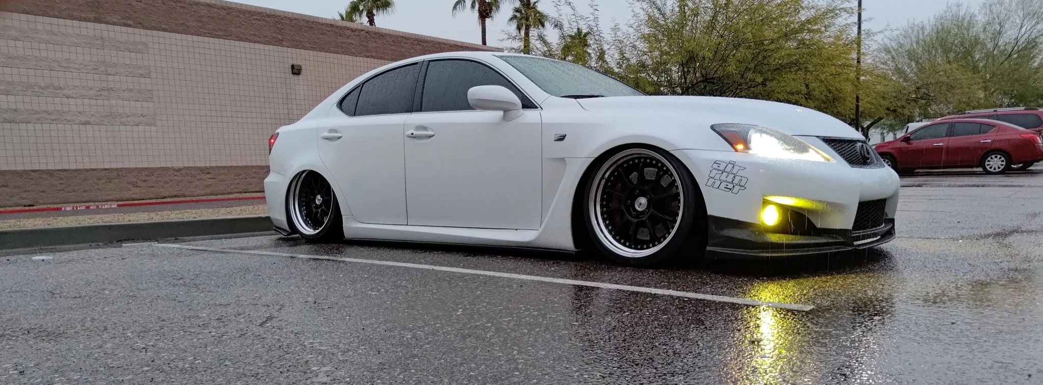 Lowered white Lexus IS F in the rain